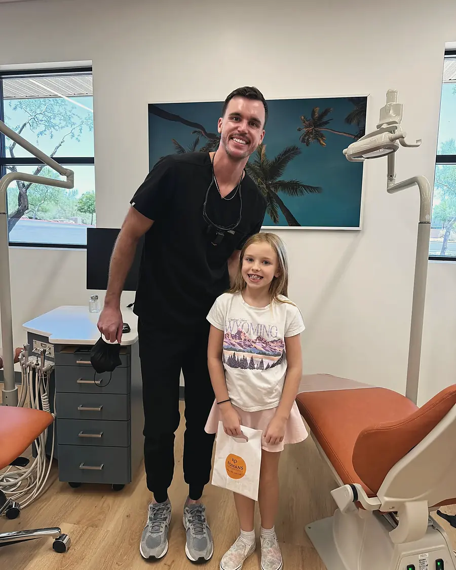 Dr. Nicholas Romans standing with a young patient in a treatment room at the Anthem office